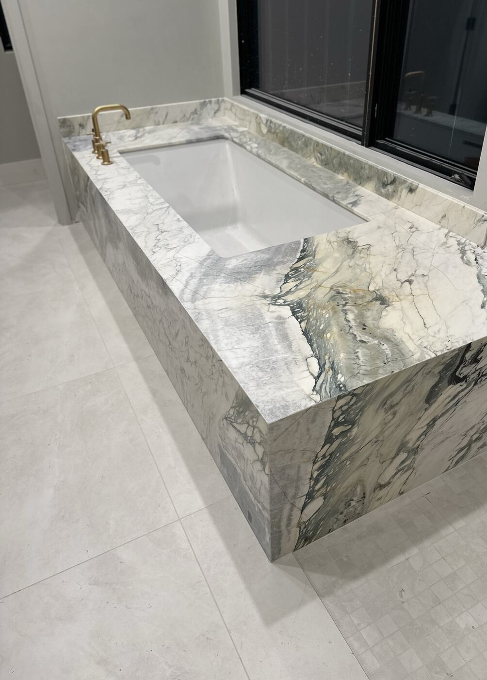 Featured project — book-matched marble tub surround