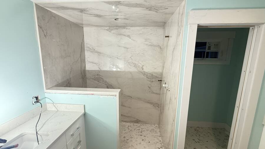 Book-matched porcelain shower enclosure