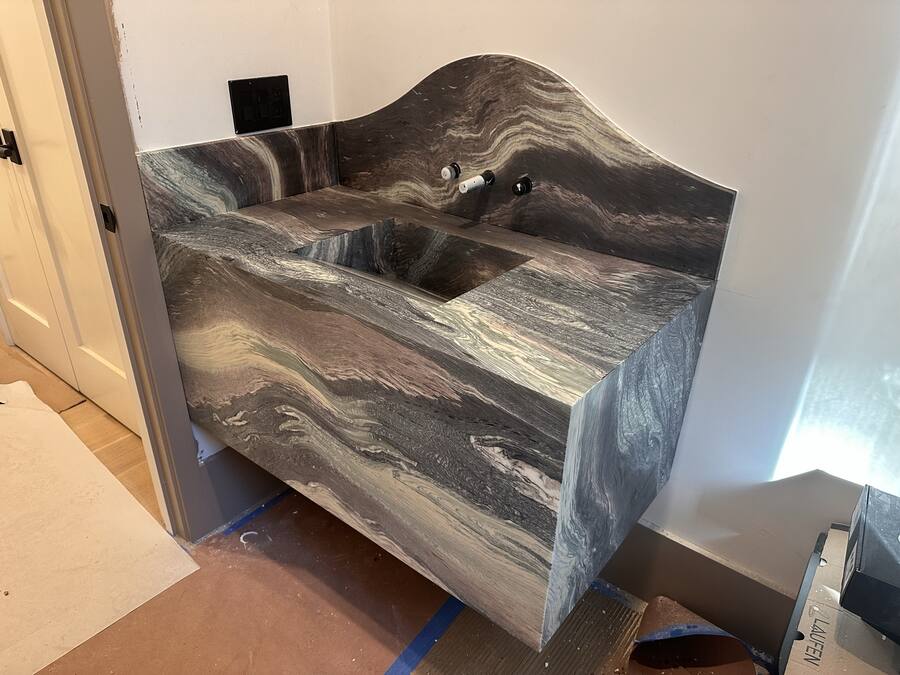 Sculpted stone vanity with wave backsplash