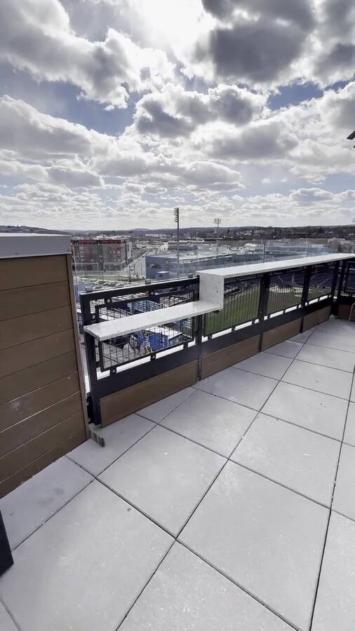 Terrace overlooking the ballpark — terrazzo ledge runs